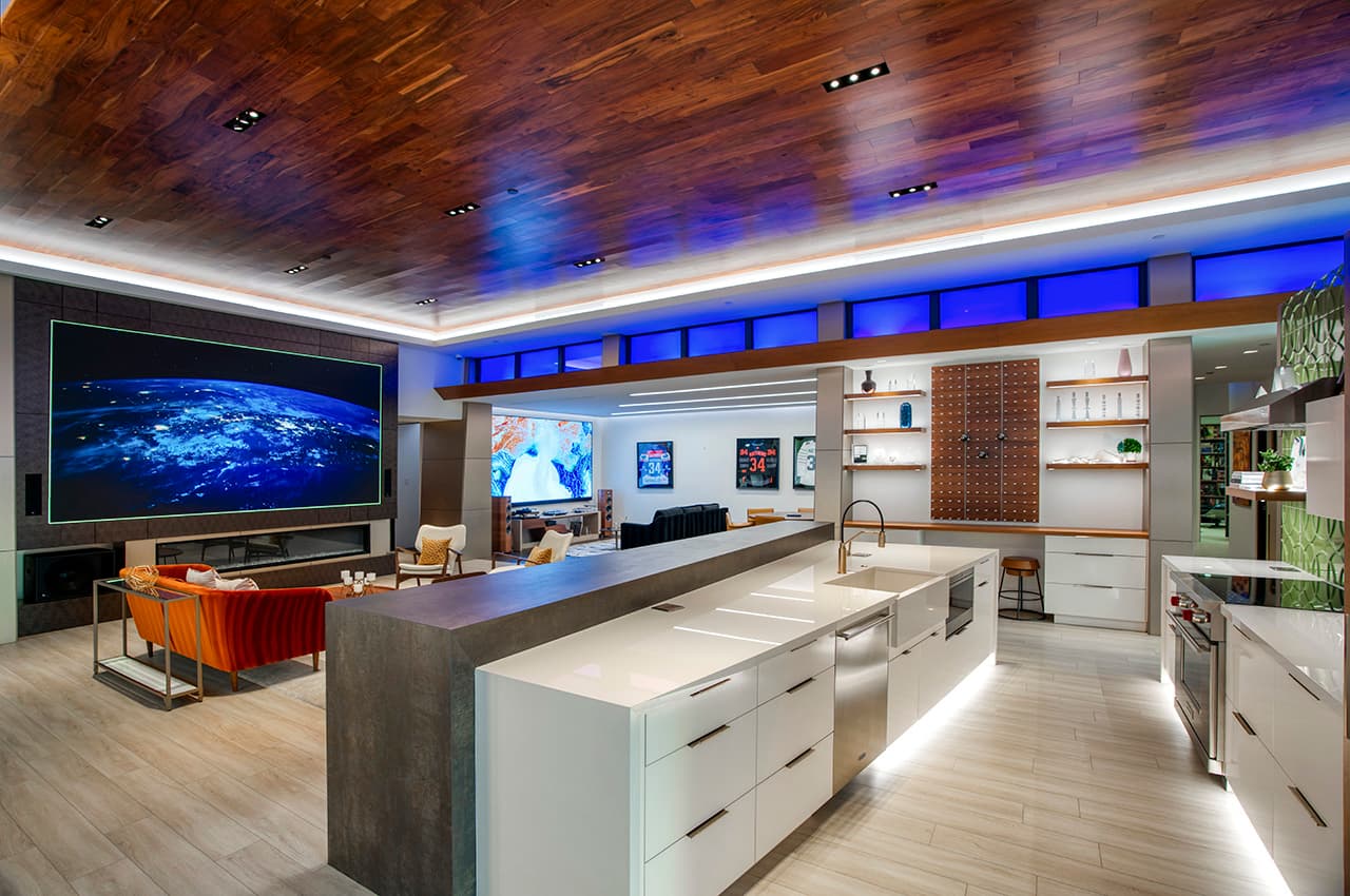 A video wall and open kitchen in a finished home