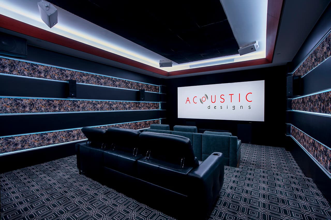The reference cinema in the showroom, screen lit, seating in the foreground